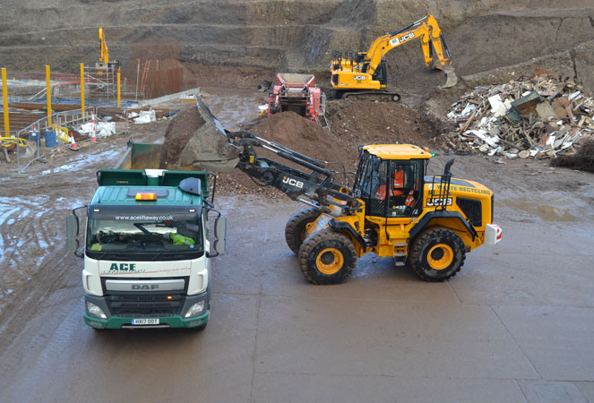 a JCB 437 Wheel Loading Shovel unloading its shovel into a lorry